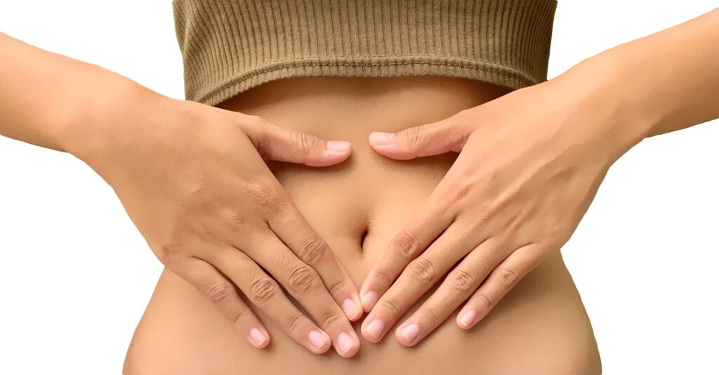 a person places their hands over their stomach