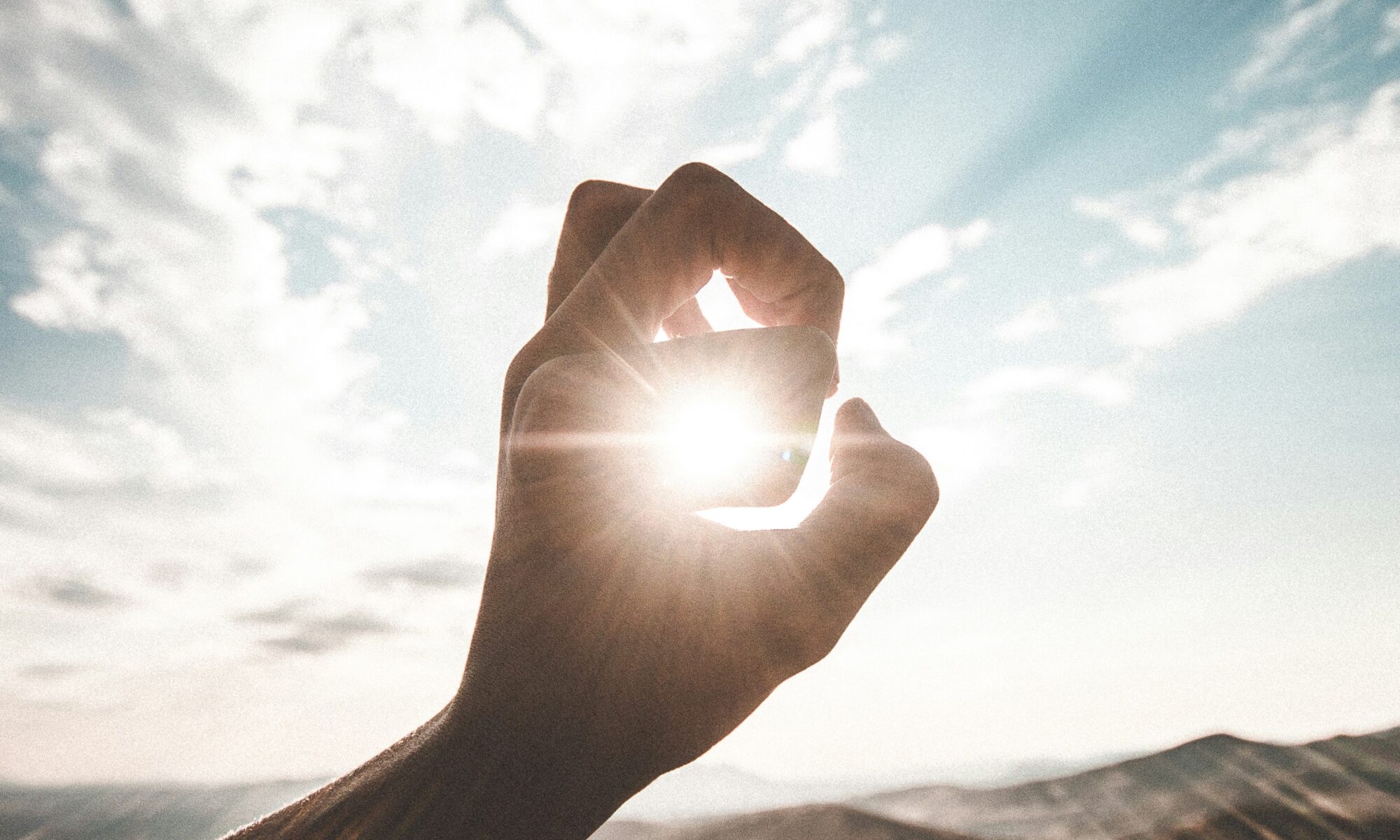 hand in front of sunshine